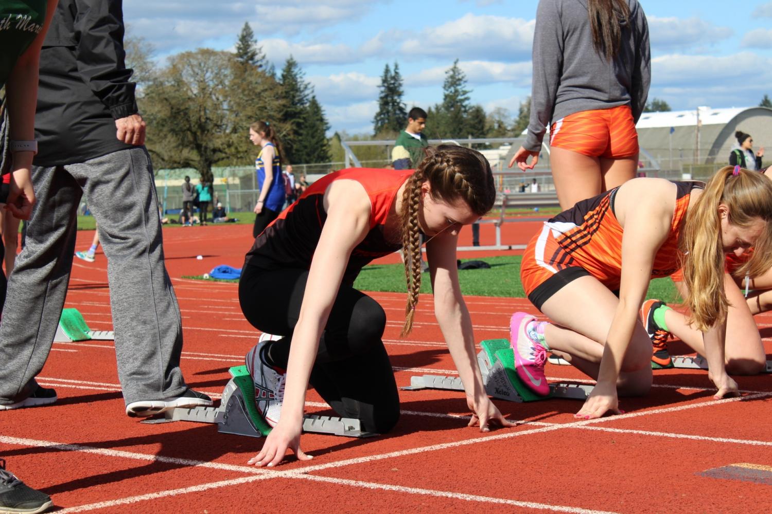 Jensyn Stanger getting ready in the blocks at the Stayton Twilight Track Meet. 