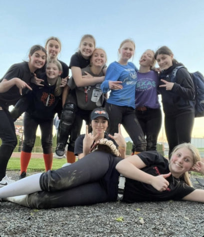 YC high school Softball team taking a picture together after practice