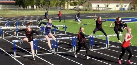 The track team competing in hurdles at a recent event. 