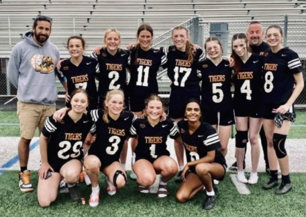 The flag football team poses after a win.