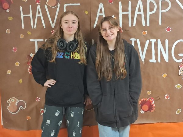 Sophomores Rylie Powell and Lola Buongiorno get ready for the holidays by posing in front of the Thanksgiving themed halls in the high school.